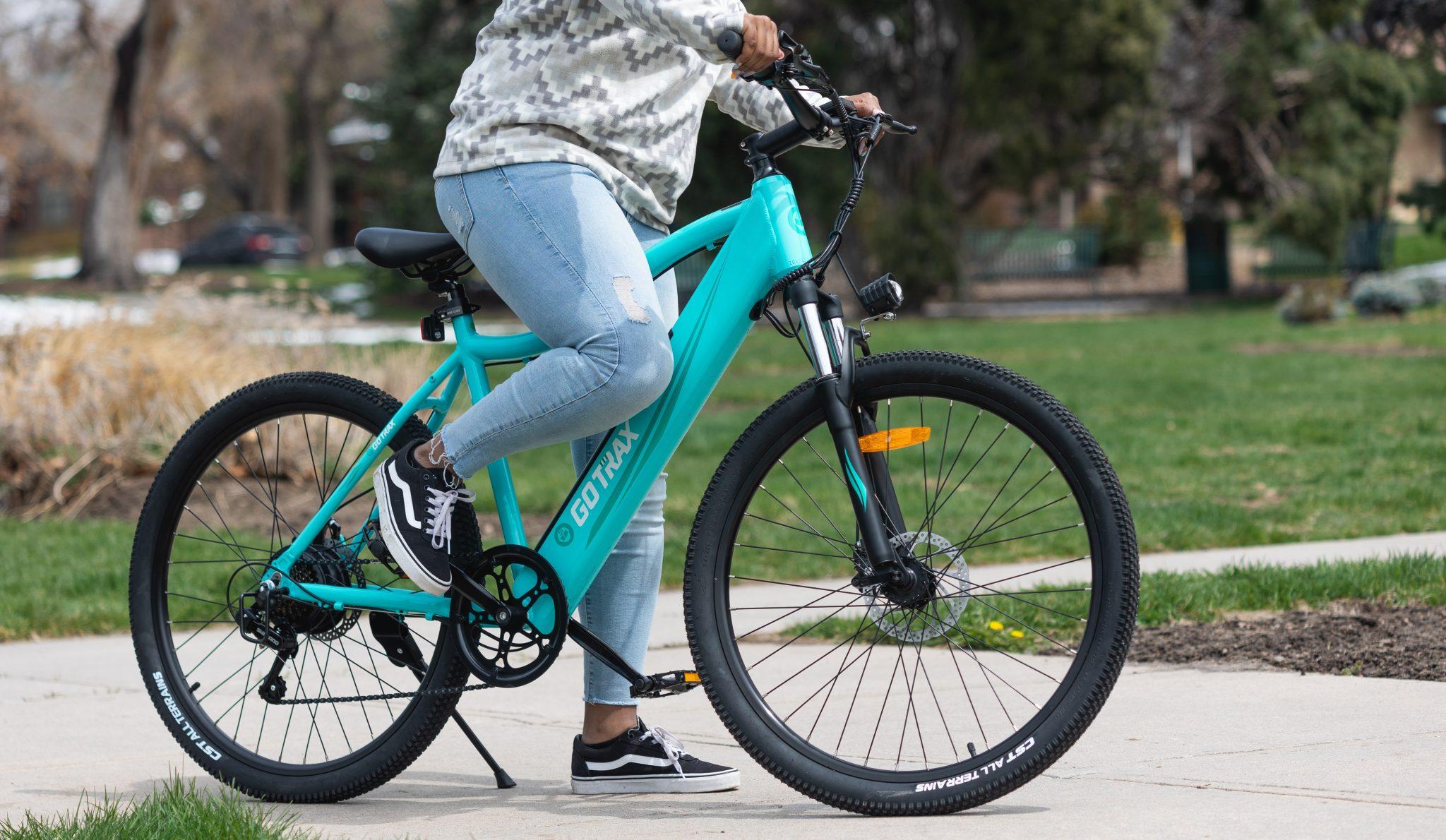 Person cycling on turquoise bike